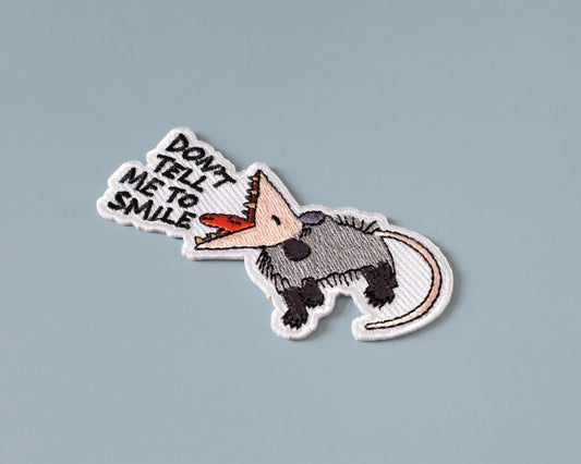 #73 Don't Tell Me to Smile Possum Iron-On Patch