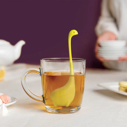 Yellow rubber duckling in a glass of tea on a table with a blurred background