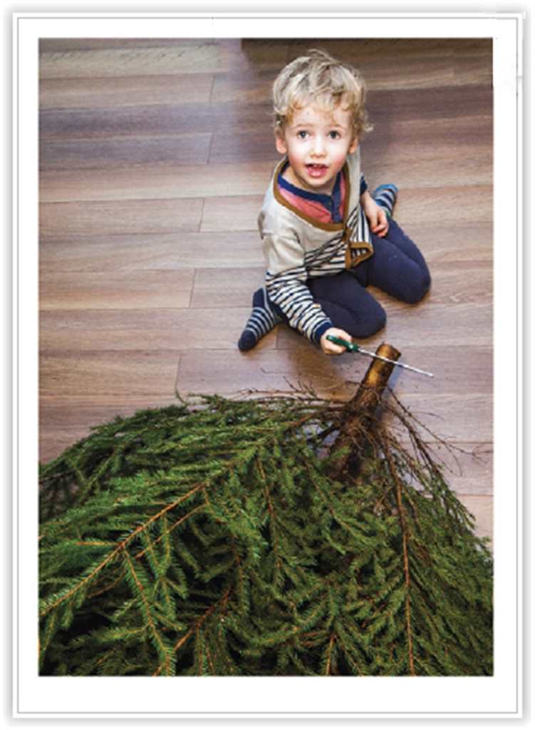 Child Sitting On The Floor Sawing A Christmas Tree Card