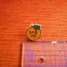 @176 Pronoun Orange Pin -She / He